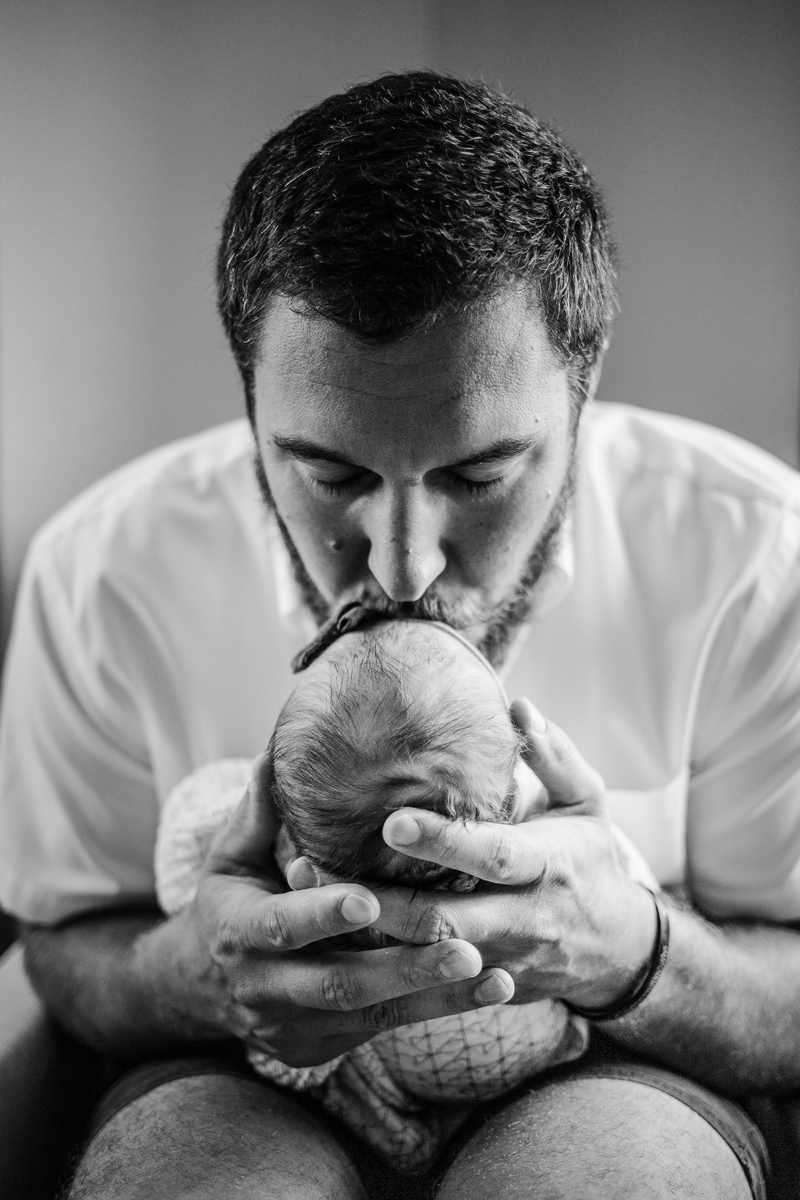 Temecula Newborn Photographer, father kissing newborn baby's forehead