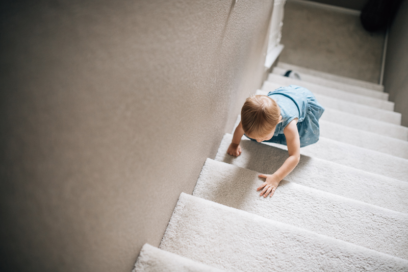 Temecula Lifestyle Documentary Photographer, little girl climbing up stairs